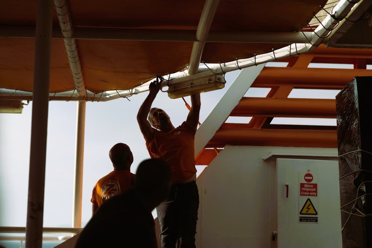 2 men installing lighting